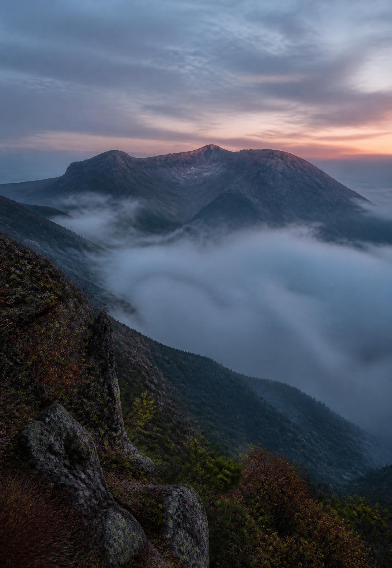 Hallasan volcano on Jeju Island at dawn with mist filling the valley